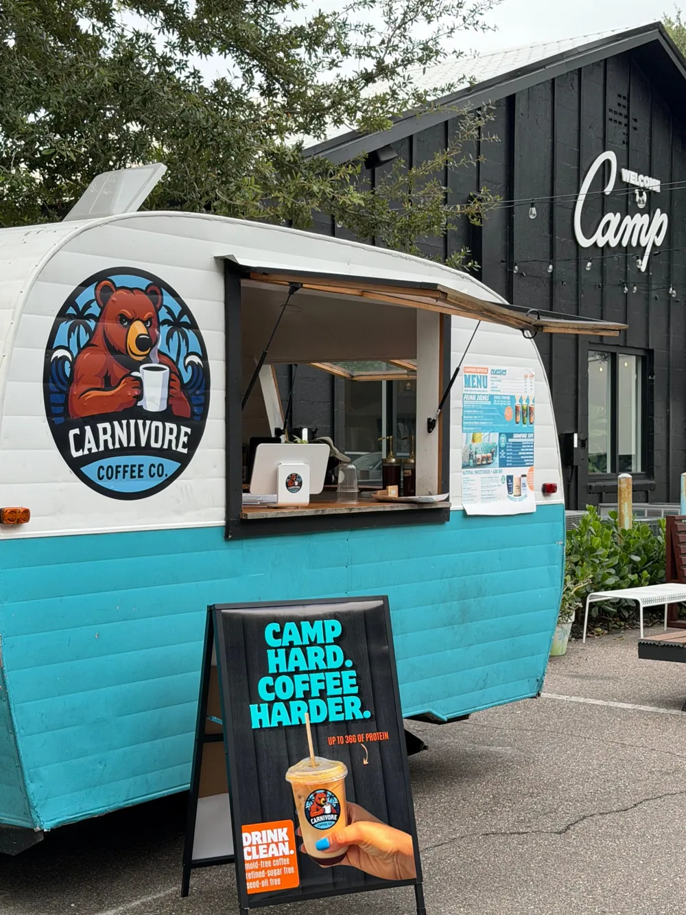 The Carnivore Coffee truck with its Camp Hard. Coffee Harder. sidewalk sign