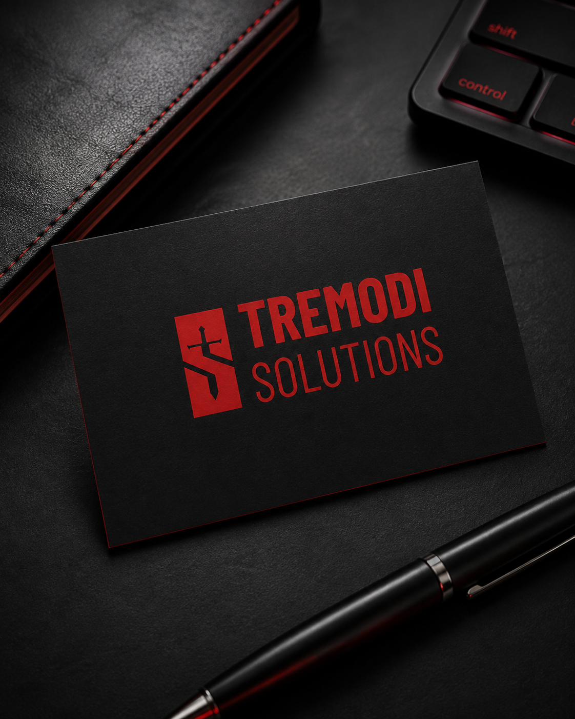 Tremodi Solutions black business card with red brand mark.